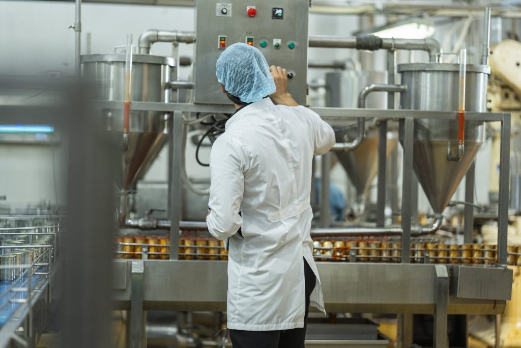 food manufacturing worker overseeing an automated utc